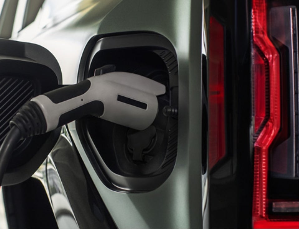 Close up of charging port with charger plugged in on a GMC Hummer EV SUV - Rico Auto Complex in GALLUP NM